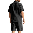 Man wearing a black pinstripe shirt and shorts set on a white background