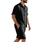 Man wearing a black pinstripe shirt and shorts set on a white background