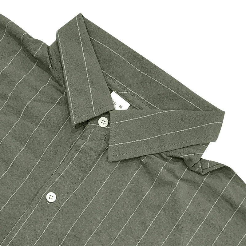 Close-up of a green pinstripe shirt with collar and buttons on a white background