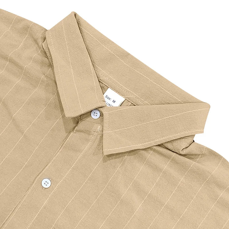 Close-up of a beige shirt with collar and buttons on a white background
