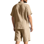 Man wearing a beige shirt and shorts set on a white background