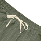Close-up of green shorts with a drawstring on a white background