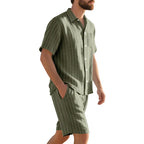 Man wearing a green pinstripe shirt and shorts set on a white background