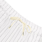 White shorts with black stripes and a drawstring on a white background