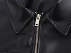 Close-up of a black leather jacket with a zipper