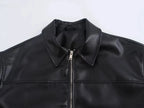Close-up of a black leather vest with a collar on a white background