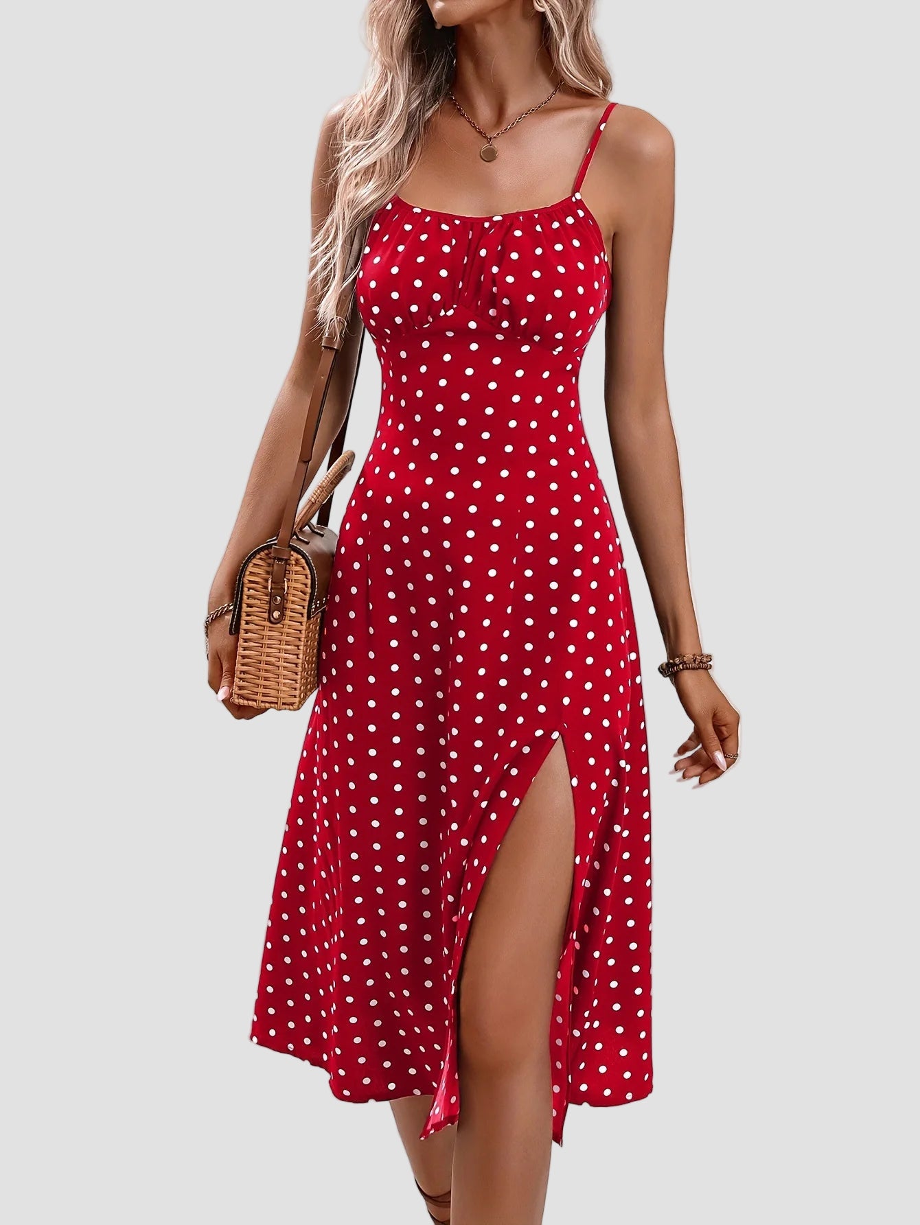 Woman wearing the Altivieri 'The Amalfi' polka dot midi dress with a high leg slit.
