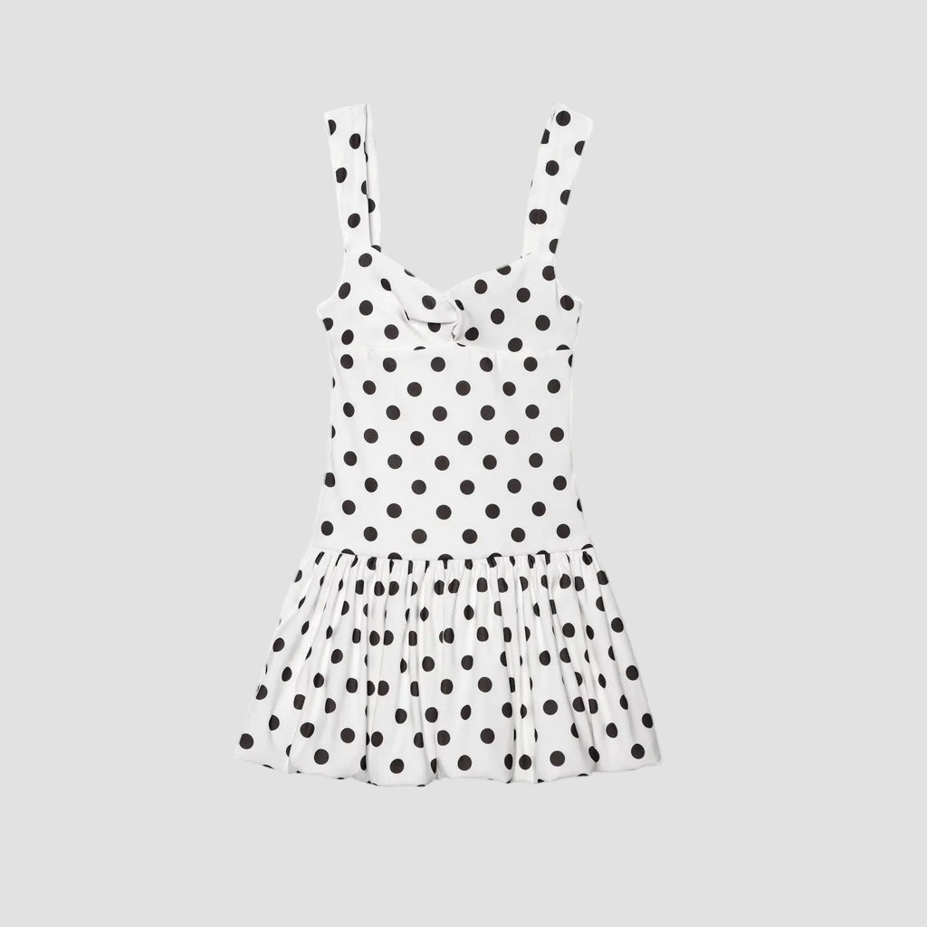 White dress with black polka dots on a white background