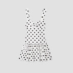 White dress with black polka dots on a white background