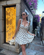 Woman wearing the Altivieri 'The St. Tropez' sexy polka dot mini dress.