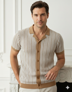 Man wearing a patterned shirt with a collar and buttons, standing against a white wall.